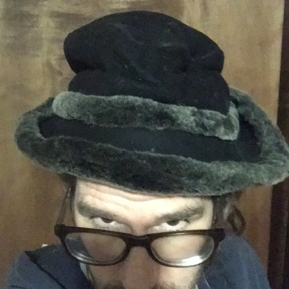 This is a black and gray fur hat for a large kid